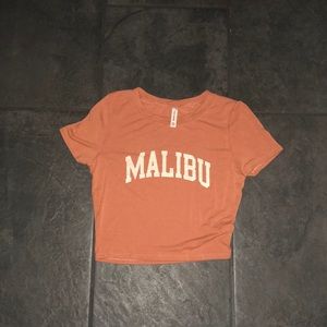 A orange tee with a Malibu logo